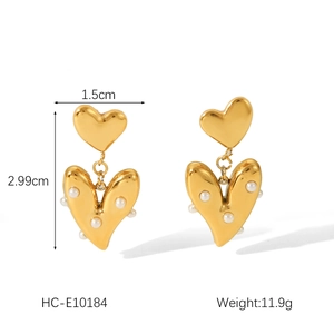 Detail view of double heart gold drop earrings with white pearls and size measurements