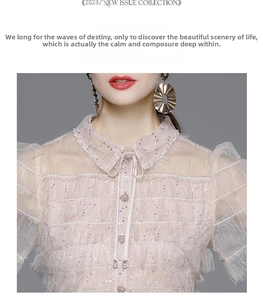 Detail of light pink lace dress with sequins, ruffled layers and decorative chest ribbon