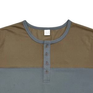 Close-up of contrast color Henley neckline with buttons and detailed fabric texture
