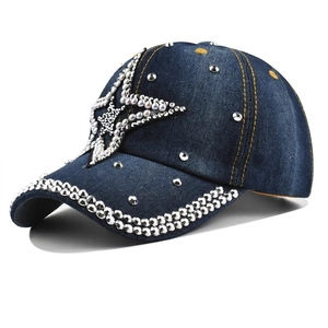 Macro detail of dark blue denim cap with rhinestone star and silver metal rivets
