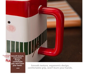 Macro detail of ergonomic handle on Christmas ceramic mug with smooth red glazed finish