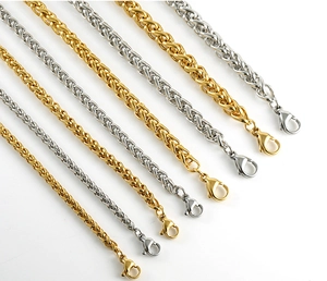 Close-up of titanium steel dragon bone chain bracelets in gold and silver finishes