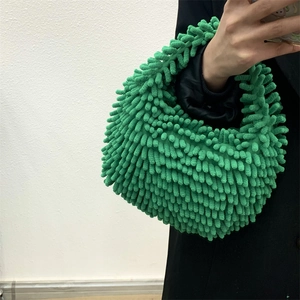 Detailed close-up of bright green chenille plush handbag with soft tufted texture