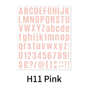 Close-up of pink alphanumeric DIY stickers with letters and numbers on a white surface