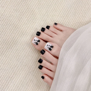 Handmade pedicure press-on nails featuring 3D bunny ears and black glossy finish