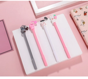 Close-up of four cute animal silicone topper gel pens on a pink and white background