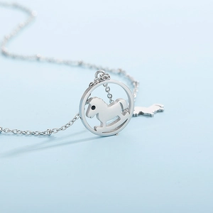 Close-up of silver stainless steel necklace with round hollow rocking horse pendant