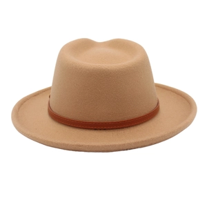 Close-up of camel felt Fedora hat featuring a classic wide brim and thin leather decorative band