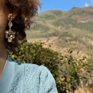 Sparkling teardrop tassel earrings with champagne rhinestones worn by a model outdoors