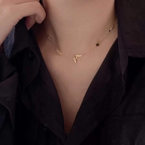 925 Sterling silver gold-plated flying bird pendant necklace worn by a model
