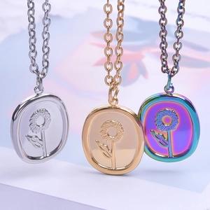 Detailed view of oval sunflower relief pendants in gold, silver, and rainbow colors