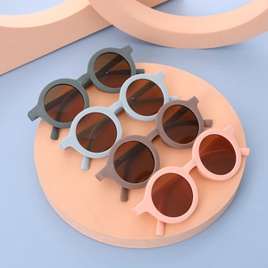 Close-up of stylish round kids sunglasses in gray, blue, brown and pink candy colors