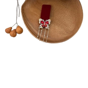 Elegant red flocked butterfly hair clip with diamond accents and silver tassel chains