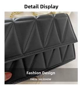 Detail of black quilted leather crossbody bag featuring modern geometric triangle stitching