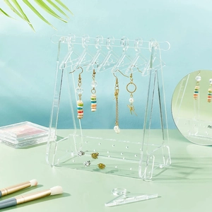 Macro shot of acrylic earring rack with mini hangers for jewelry organization