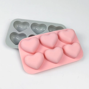 Detail of pink and grey 6-cavity heart silicone molds for mousse cake and chocolate