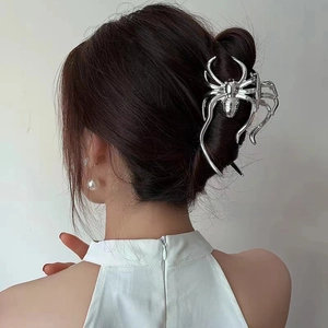Detailed view of a large silver spider hair claw clip with a polished metallic finish
