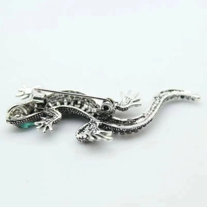 Detailed back view of silver lizard brooch showing the secure safety pin clasp mechanism