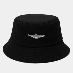 Detailed view of shark embroidery on a black cotton bucket hat with dense stitching