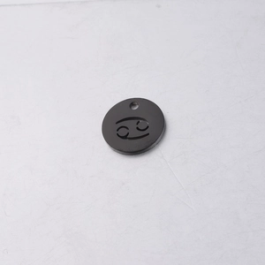 Macro detail of 12mm black mirror titanium steel pendant with Cancer zodiac cutout