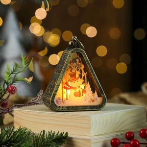 Detail of vintage Christmas lantern with snowman scene and warm glowing LED light