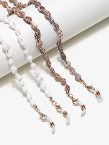 Detail of natural conch shell eyewear chain with gold metal clips and anti-slip rings
