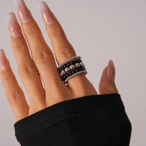 Detail of multi-layer beaded stackable ring with black and silver beads on hand