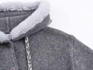 Detail of grey knitted cardigan showing plush faux fur hood and braided drawstring cord