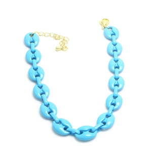 Close-up of bright blue resin oval chain necklace with gold metal lobster clasp detail