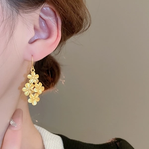Elegant gold flower drop earrings with matte finish and four-petal floral design