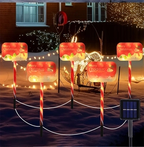 Outdoor solar Christmas path lights with five red snowman LED lollipop stakes in the snow