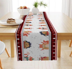 Close-up of linen Christmas table runner featuring cartoon fox and bear motifs on wood