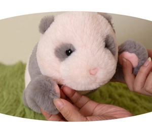 Close-up of soft pink and grey panda plush toy with detailed heart-shaped nose and long fur