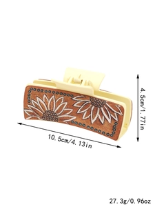 Detail view of sunflower pattern leather hair claw with dimensions and weight specs