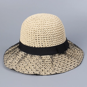 Detailed view of handmade sun hat with elegant lace trim and black polka dot mesh veil