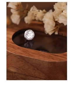 Detail of S999 sterling silver stud earrings with large central cubic zirconia and halo setting