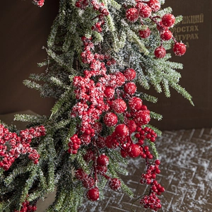 Christmas red berry branches with frosted pine needles and snow for holiday decoration