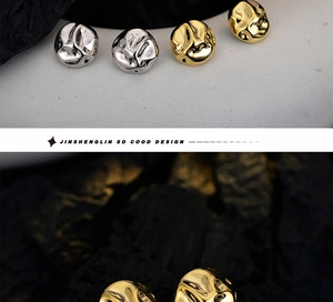 Close-up of irregular lava texture S925 silver earrings in gold and silver finish