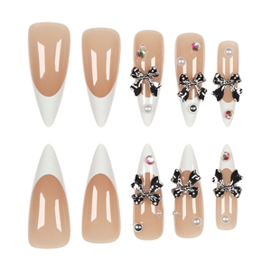 Long stiletto French press-on nails with pearl bow and rhinestone details