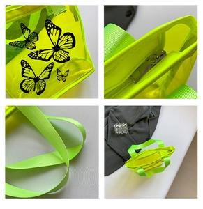 Detail view of neon green transparent PVC tote bag with butterfly prints and zipper closure