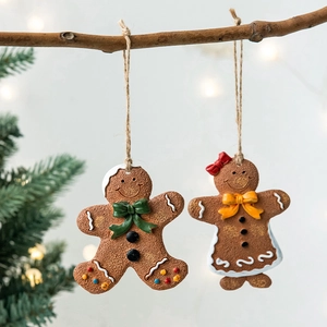 Set of gingerbread man and woman Christmas ornaments with festive icing details