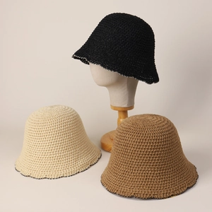 Detailed knit texture of crochet bucket hats in black, beige, and khaki neutral tones
