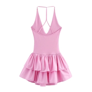 Detail of pink halter neck dress featuring deep V-neck, thin straps and ruffled hemline