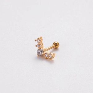 Macro detail of gold curved bar stud earring featuring five sparkling round cubic zirconia