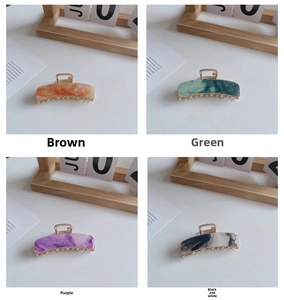 Detail of 7.5cm rectangle claw clips in marble brown, green, purple, and black-white tones