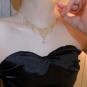 Detail of vintage 24K gold plated lace choker with tassels and elegant pearl pendant