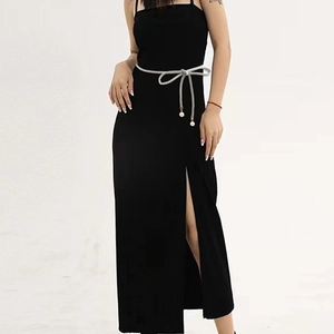 Detail of high-slit knitted dress with slim braided waist belt and pearl accents