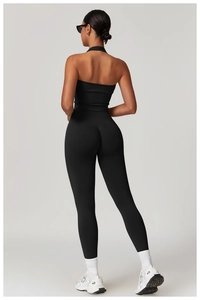 Back view of high waist yoga leggings and halter top in black textured stretch fabric