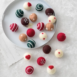 Handmade wool felt balls for Christmas tree hanging in red, green and white colors