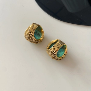 Detailed macro view of vintage gold ring with turquoise stone and AB engraving
